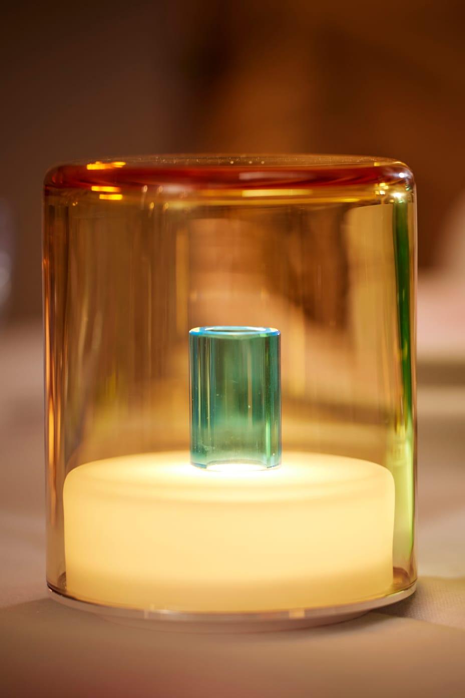 Glass container with a glowing interior on a blurred background
