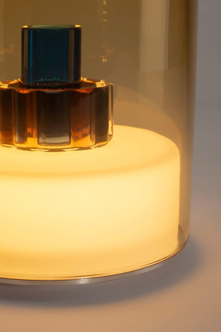 Perfume bottle with a glowing base on a neutral background