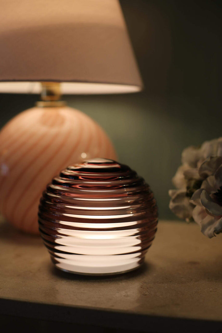 Decorative lamp with ribbed design on a surface