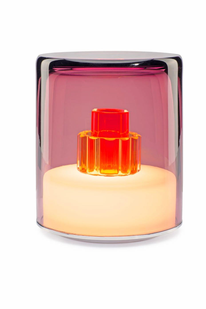 Modern glass lamp with a red interior on a white background