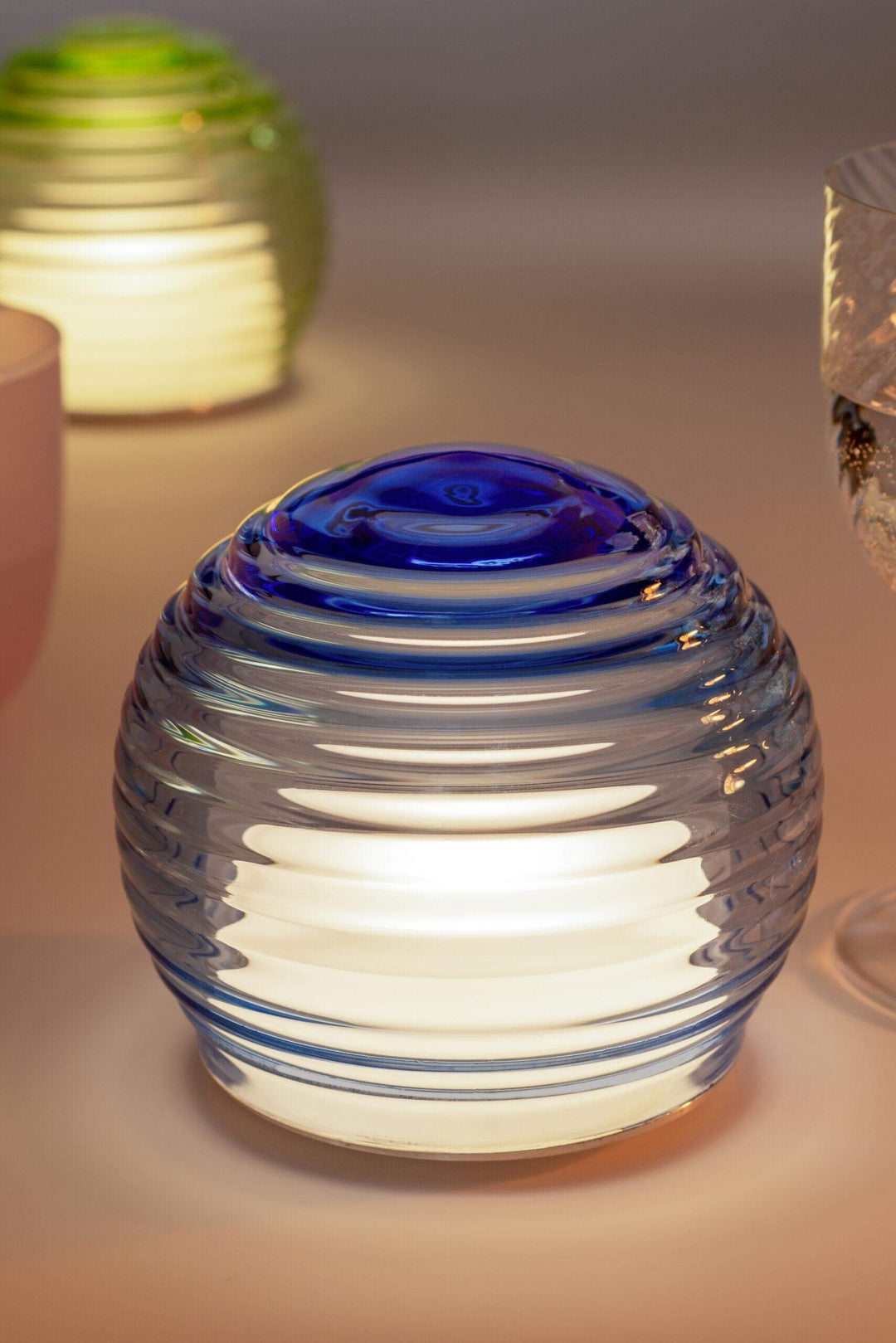 Glass lantern with blue top on a blurred background